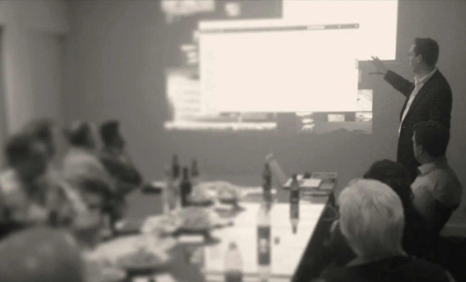 Adrian Barkus presenting a technology briefing to a board.